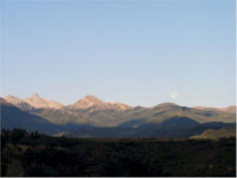 As the sun rose and the moon set, I captured a hot air balloon rising (5 o'clock to the moon)